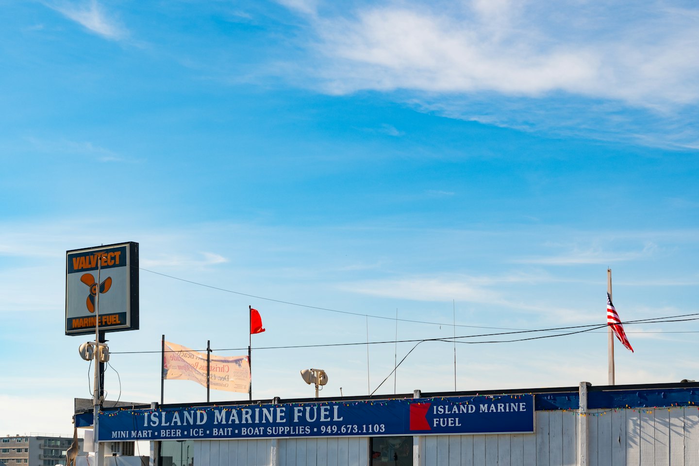 White building with Valvtect and Island Marine Fuel signs.